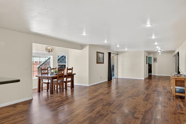 Expansive main living area featuring wood-finish flooring, recessed lighting, and neutral wall tones
