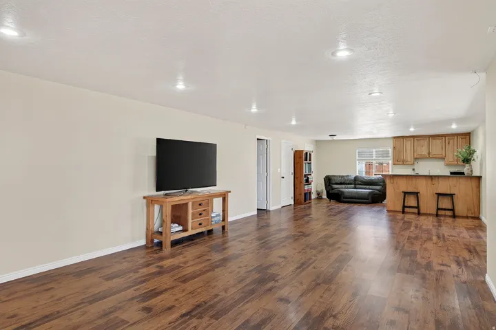 Spacious interior featuring wood-finish flooring and recessed lighting