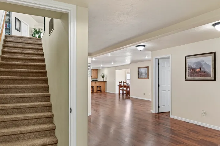 Open-concept interior featuring wood-finish flooring, recessed lighting, and a neutral color palette
