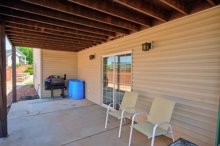Covered concrete patio with exposed wood joist ceiling