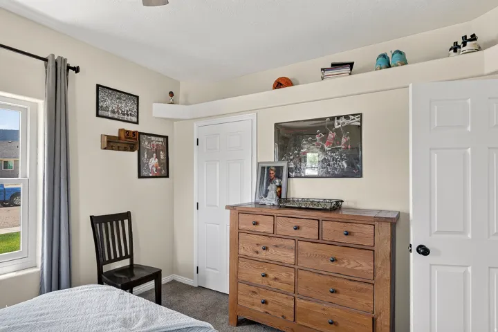 Neutral-toned walls featuring white trim, a multi-pane window with gray drapes, and a white six-panel door