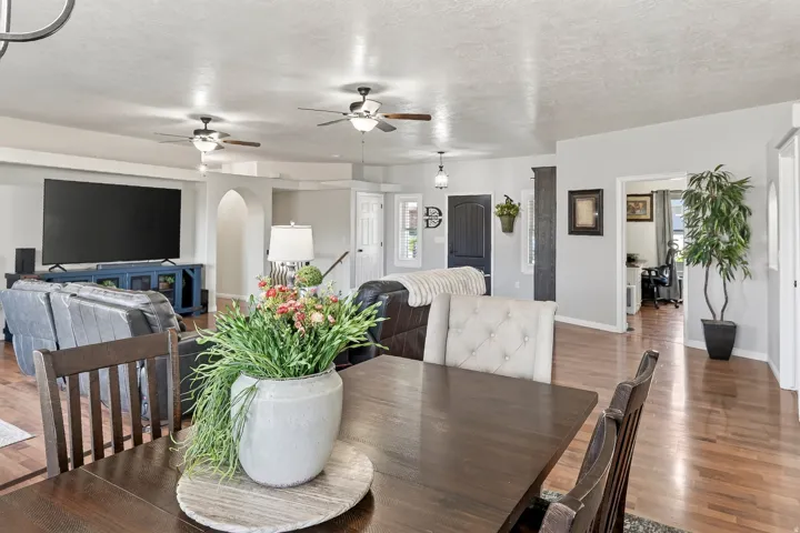 Hardwood-finish flooring extends through an open-concept interior featuring light gray wall tones