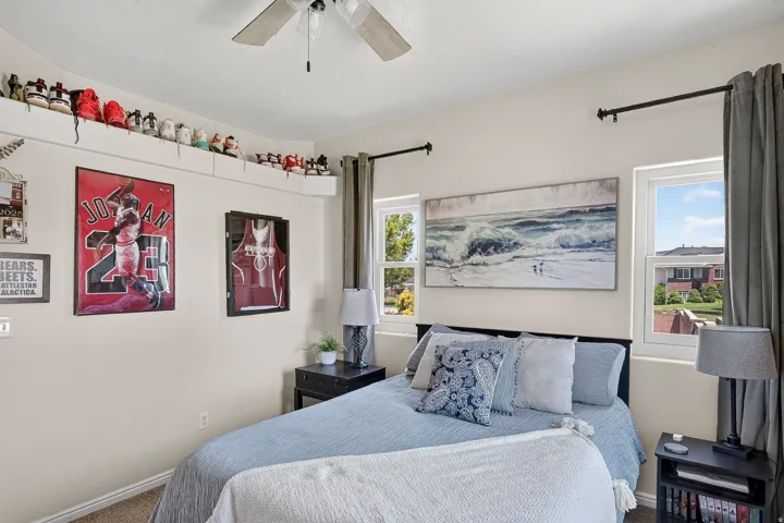 Bright interior space featuring dual windows, a ceiling fan, and neutral wall tones