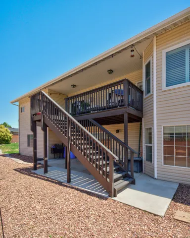 Two-story outdoor deck with rich brown railings and stairs, providing outdoor access to both levels