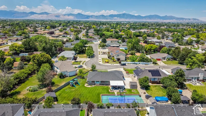 Expansive residential area featuring a dedicated sports court, above-ground pool, and covered patio