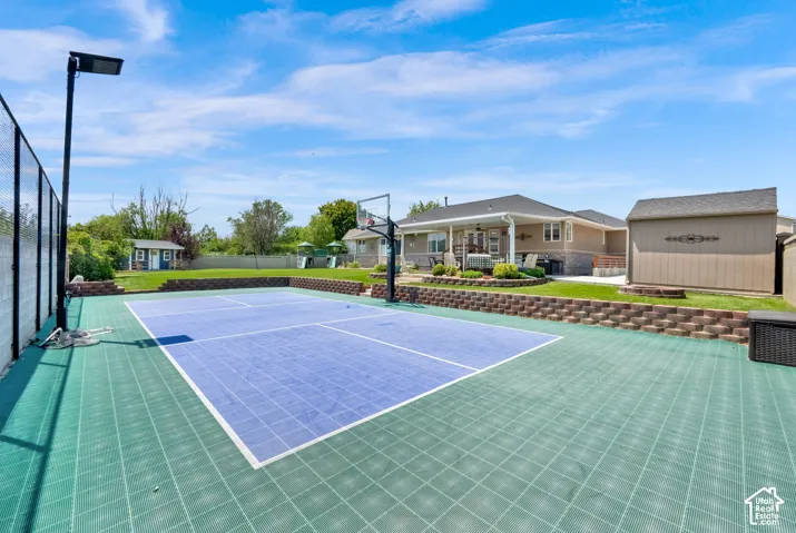 Multi-sport court with a basketball hoop and dedicated lighting