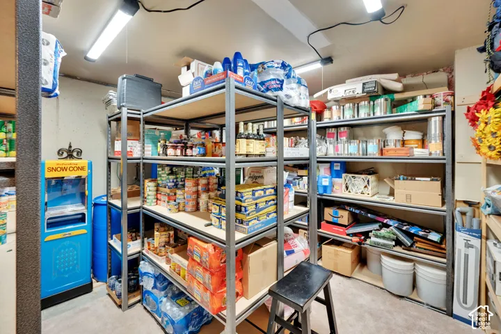 Utility room with multiple rows of metal shelving for extensive storage