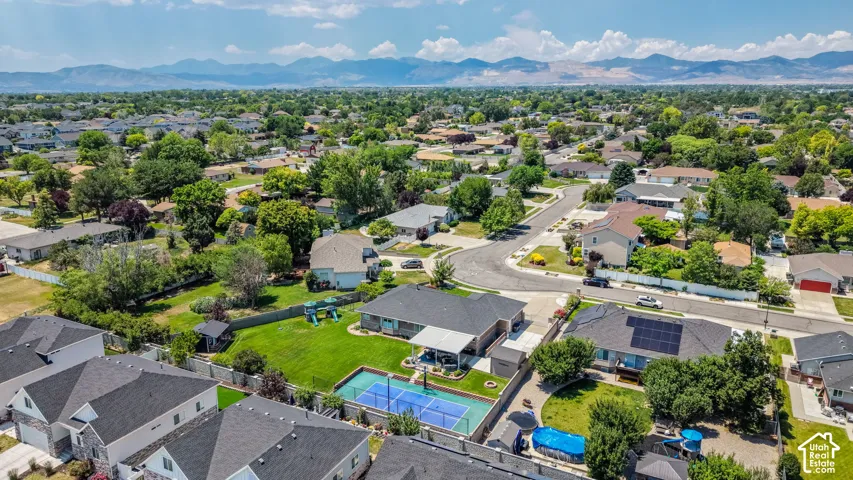 Aerial perspective showcasing a residential neighborhood with distant mountain ranges