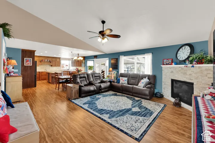 Vaulted ceilings accentuating the open-concept living area with wood-finish flooring