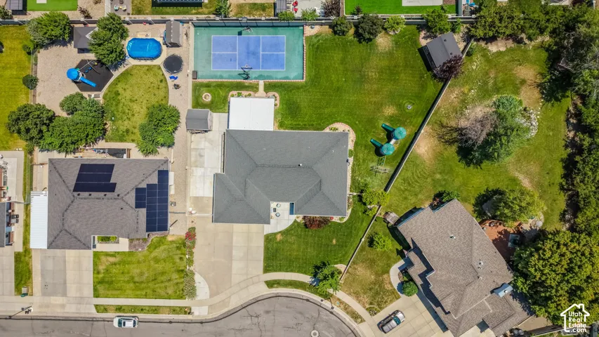 Expansive property featuring a tennis court, swimming pool, and multiple detached structures