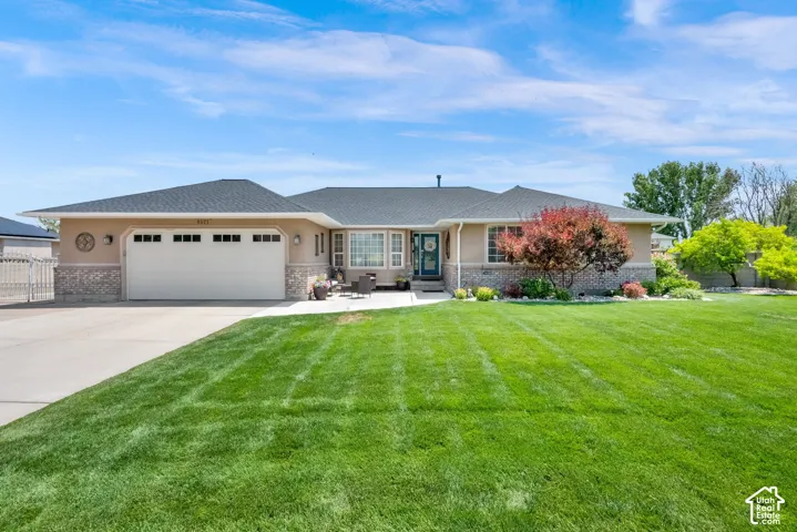 Ranch-style exterior featuring stucco siding and a stone accent facade