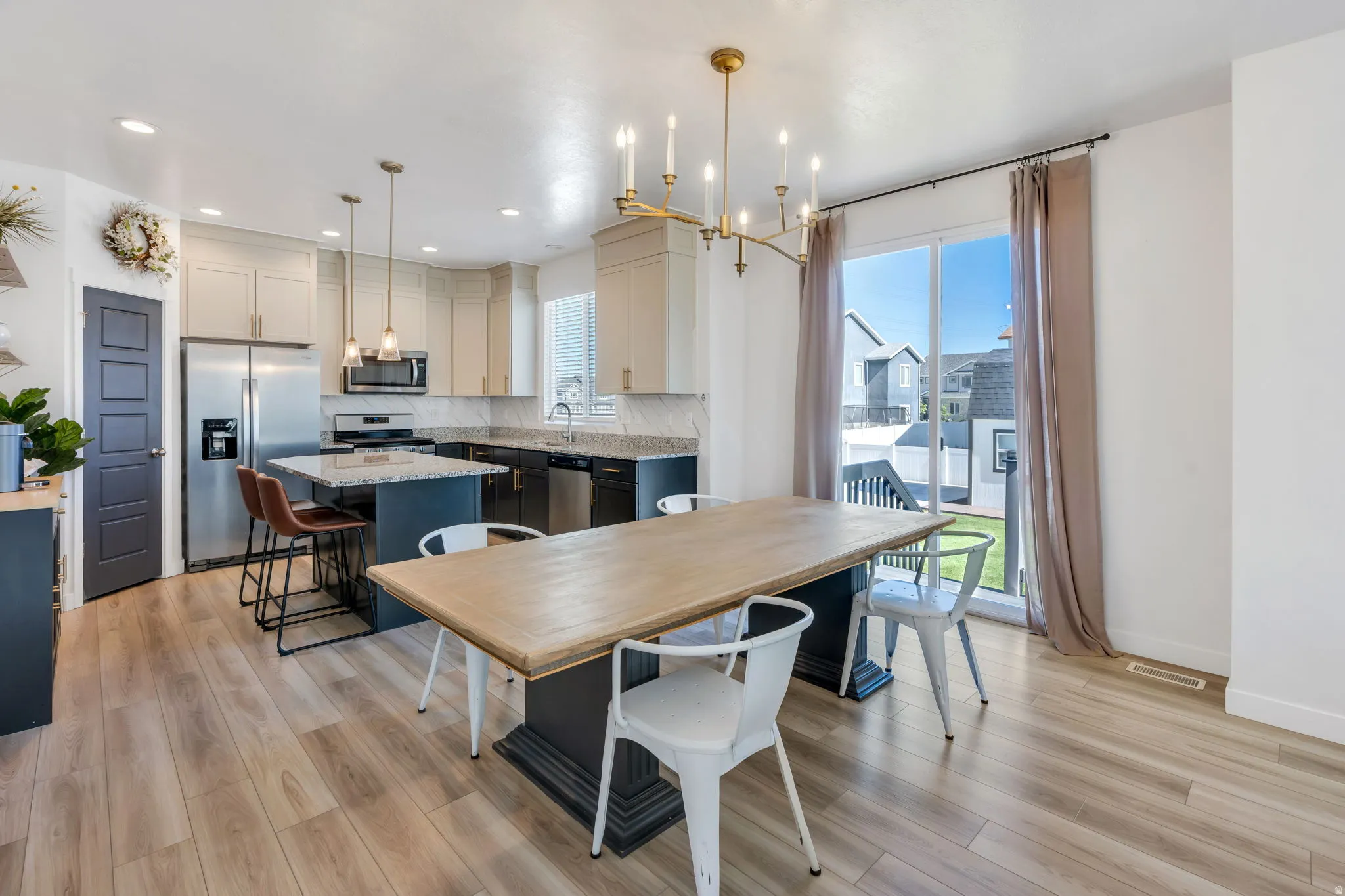 Open-concept kitchen and dining area featuring light wood-finish flooring