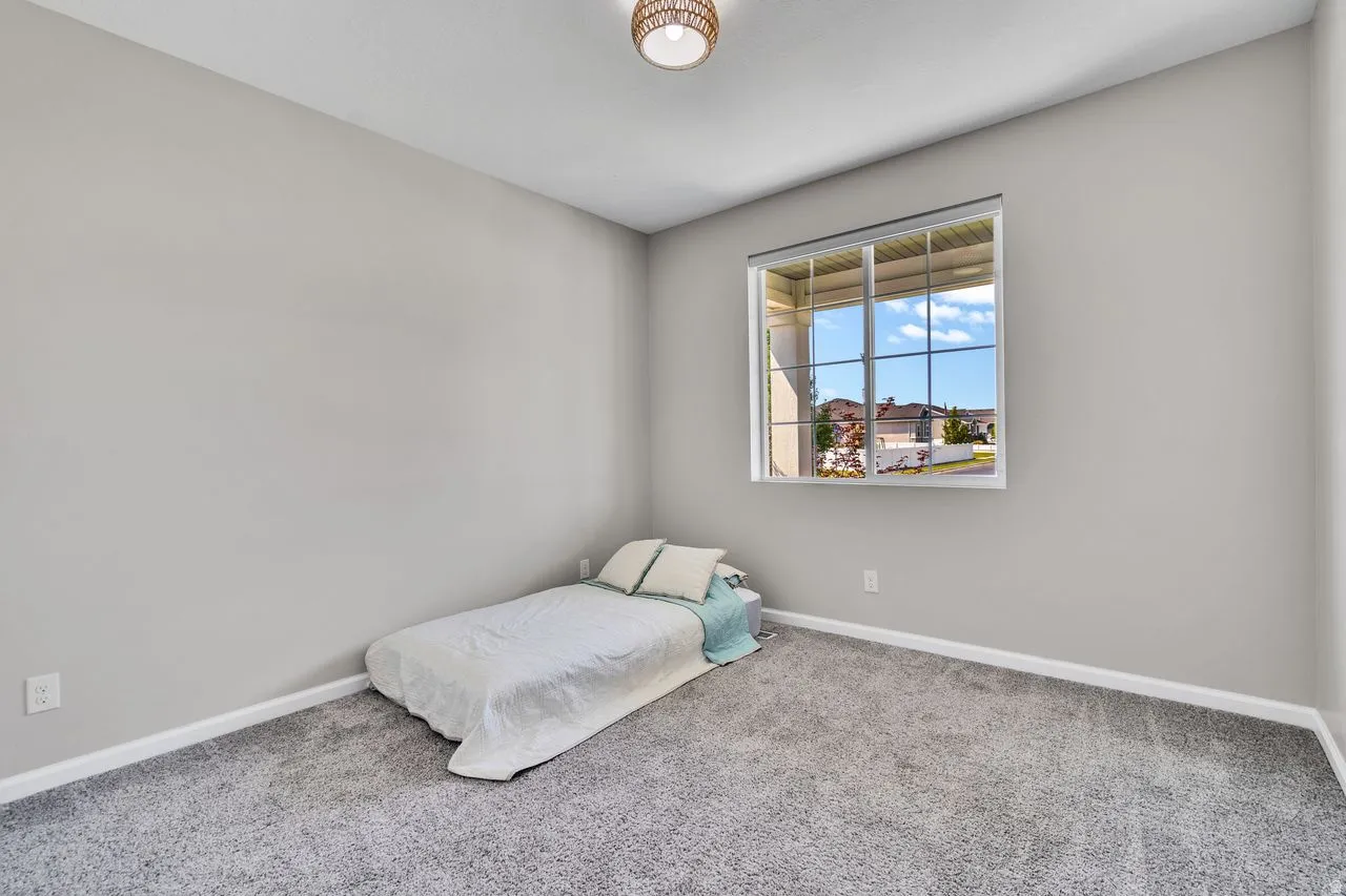 Carpeted room with light grey walls and white trim