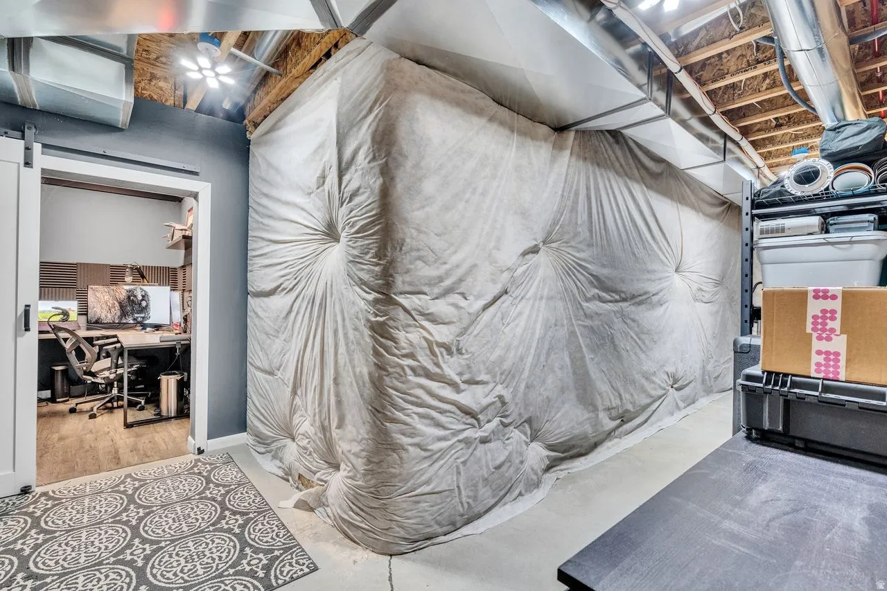 Dedicated workspace featuring wood-finish flooring and acoustic paneling