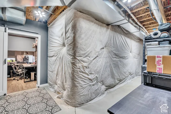 Dedicated workspace featuring wood-finish flooring and acoustic paneling