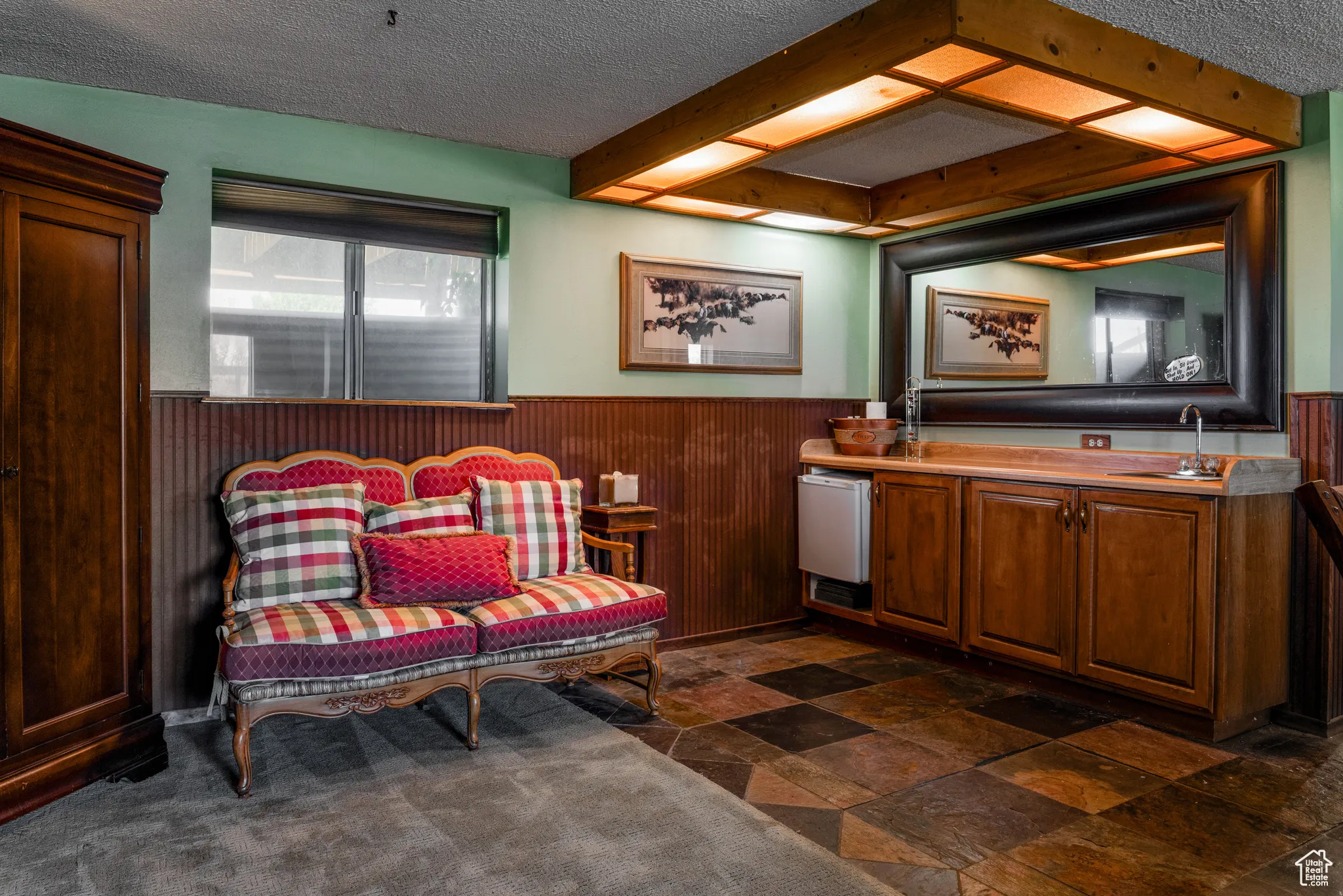Built-in wet bar featuring wood cabinetry, integrated sink, and mini-refrigerator