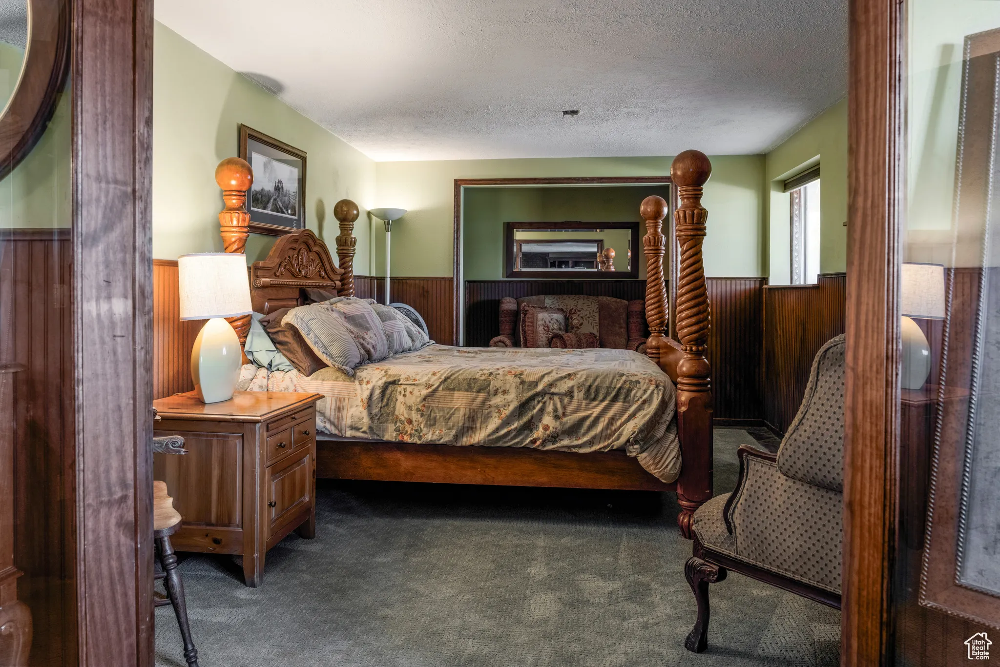 Interior room featuring wood-paneled walls and light green painted walls