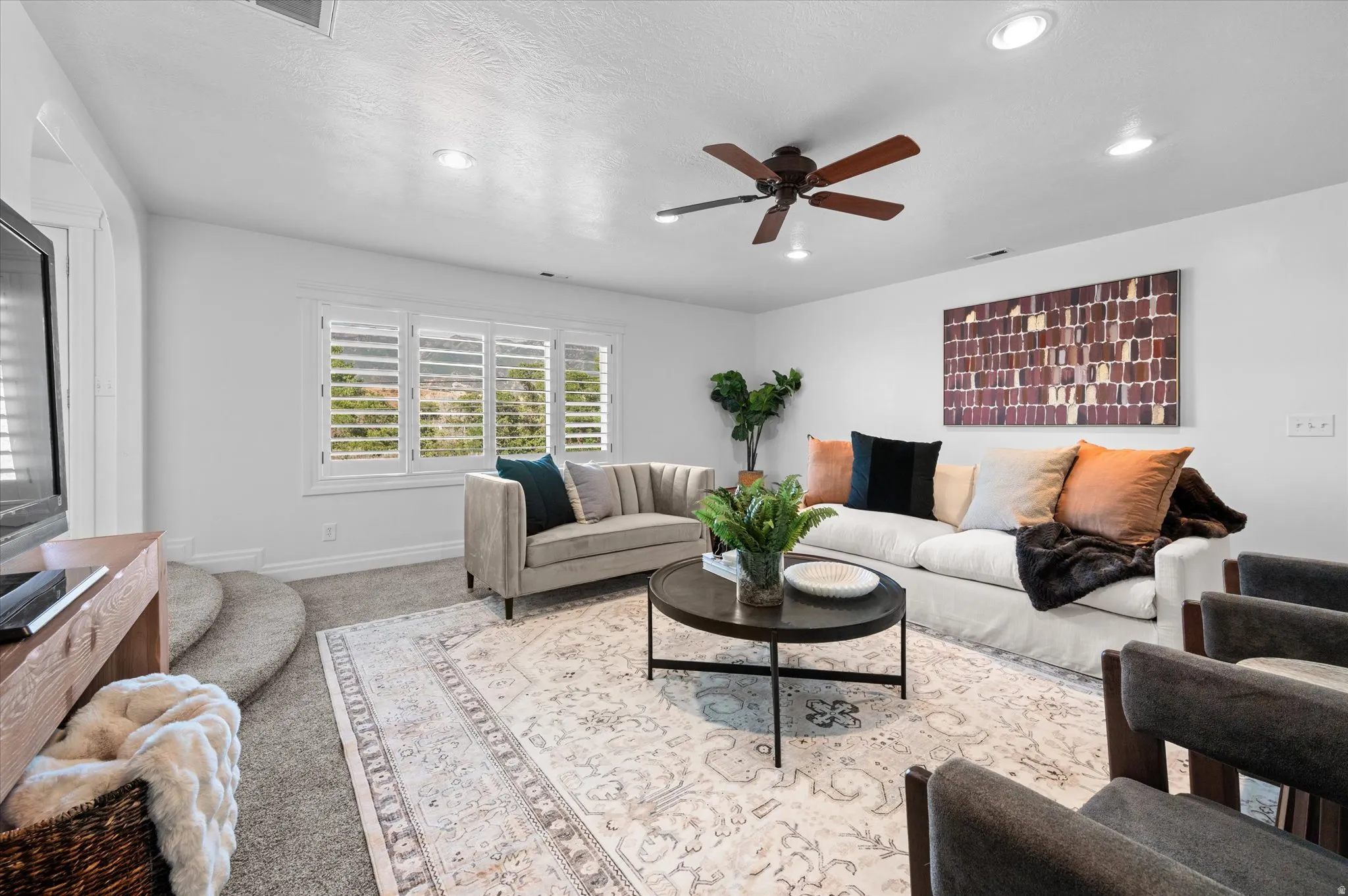 White walls with recessed lighting and a ceiling fan