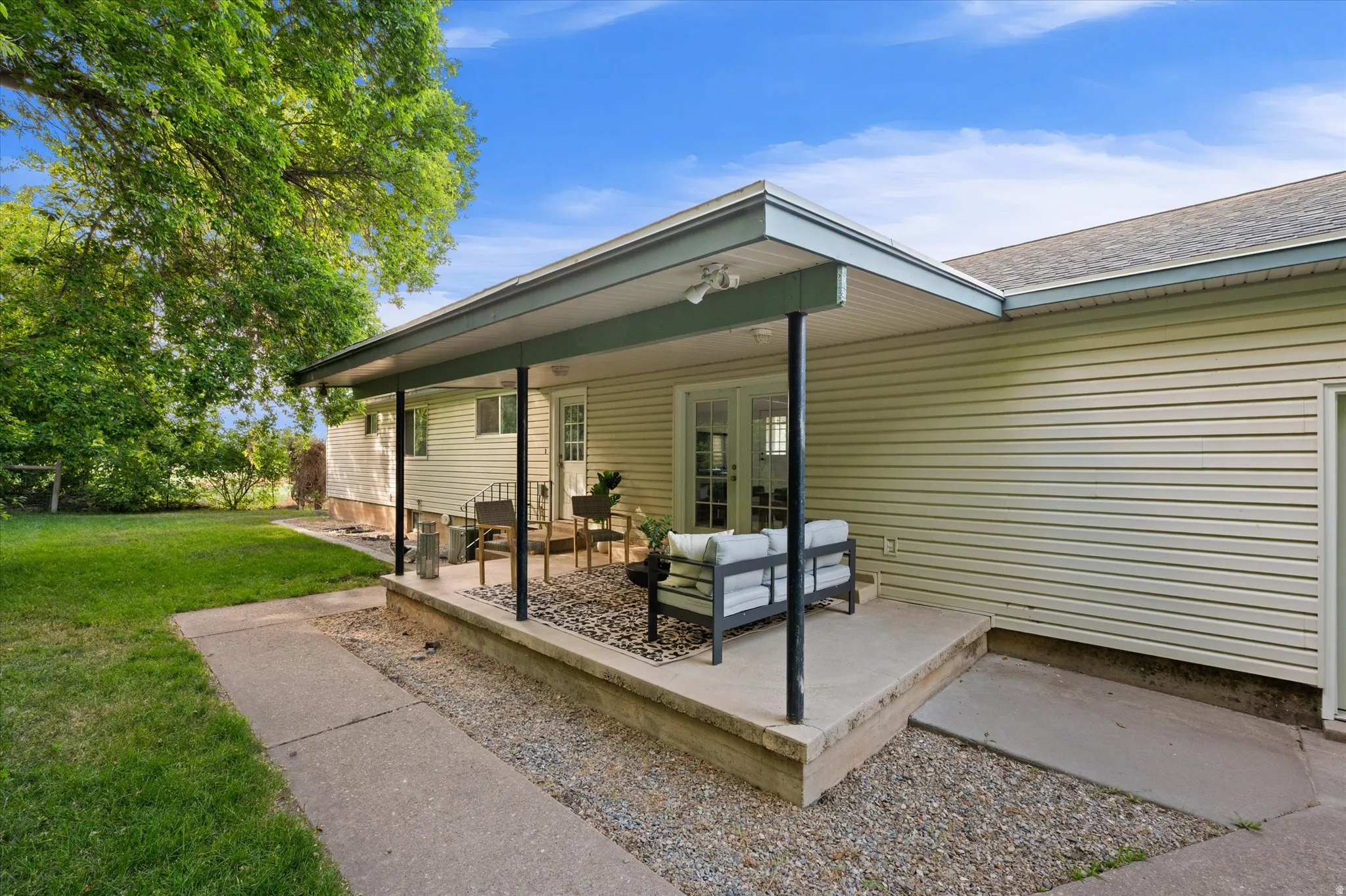Covered patio featuring a concrete slab foundation, recessed lighting, and black support columns