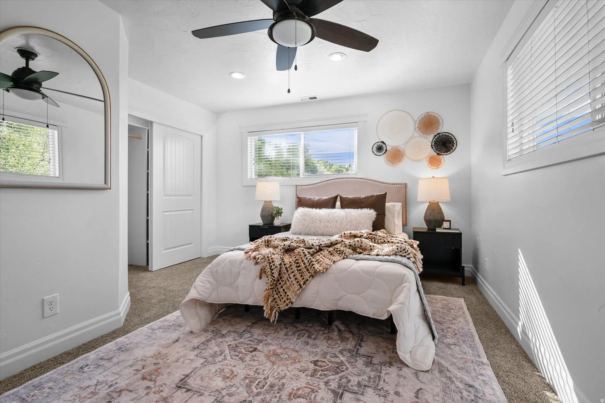 Carpeted bedroom featuring a ceiling fan with integrated lighting, recessed lighting, and white baseboards
