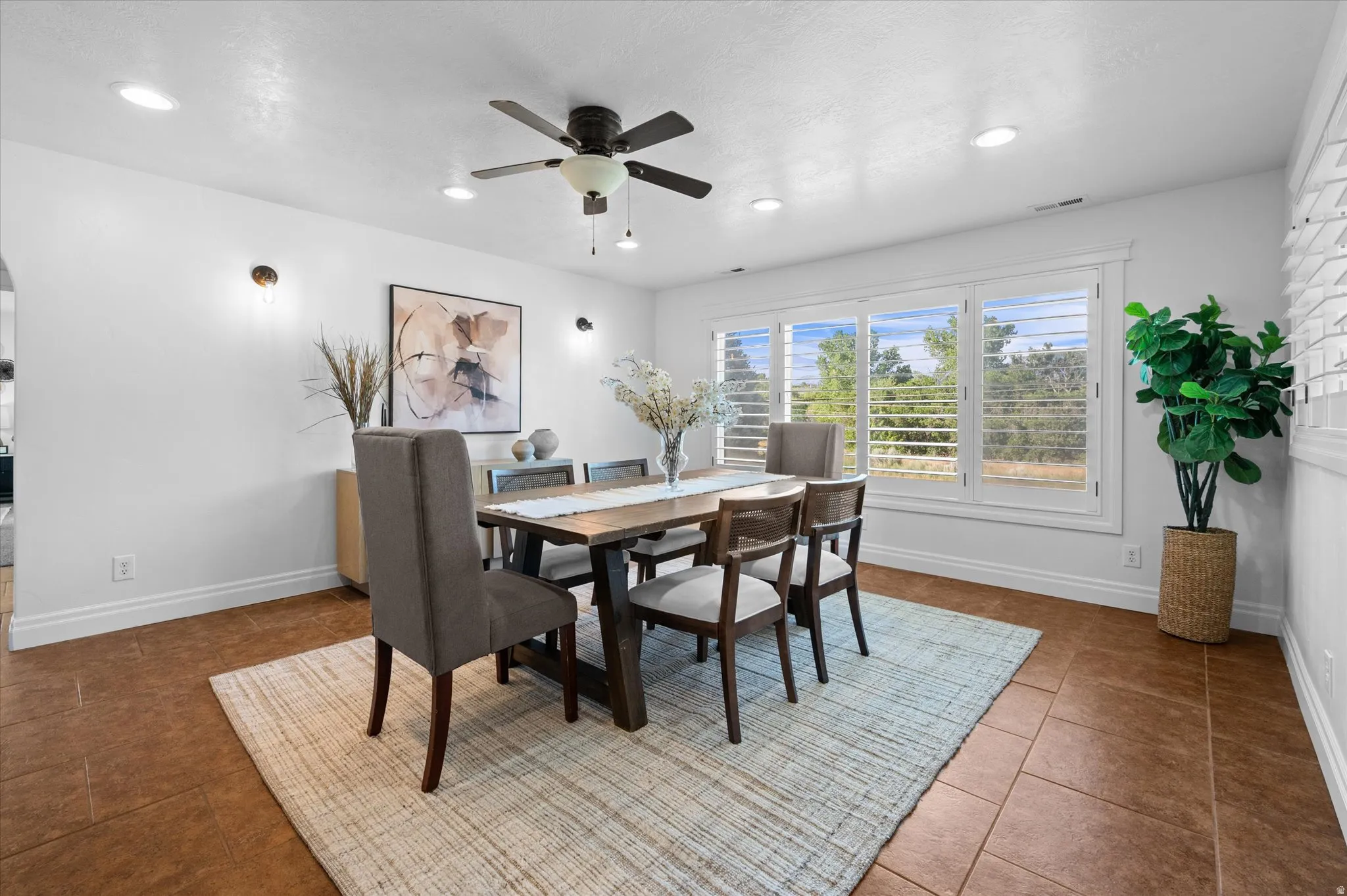 Dining area featuring tile flooring, white baseboards, and bright white walls