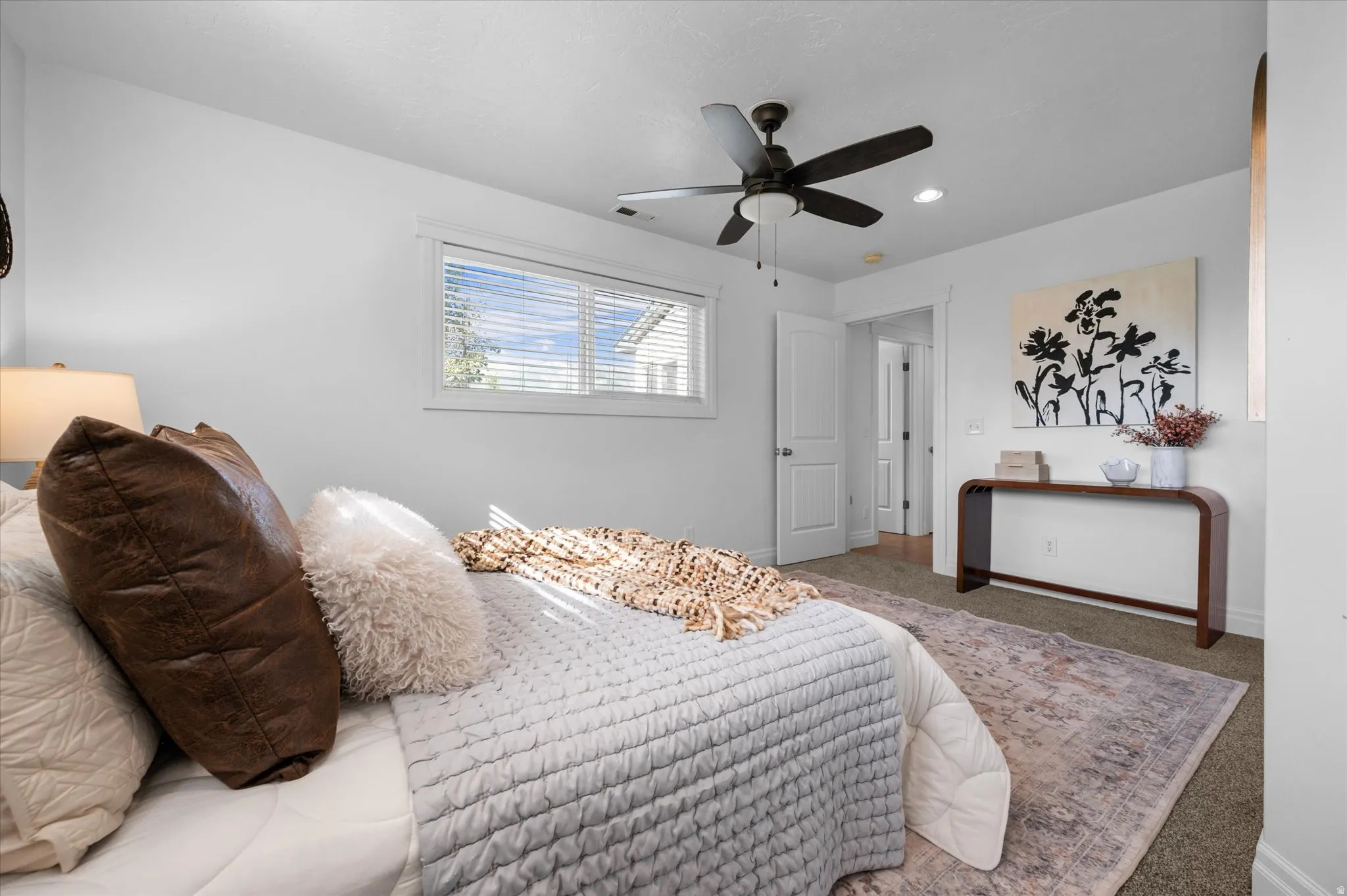 Bedroom featuring a window with horizontal blinds, a ceiling fan with integrated lighting, recessed lighting, and neutral-toned carpeting