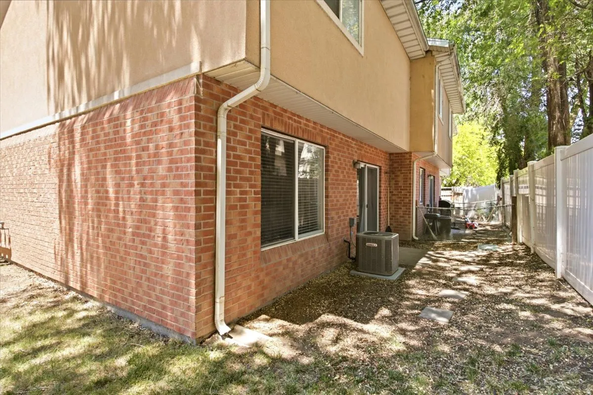 Exterior featuring a red brick lower level and stucco upper level