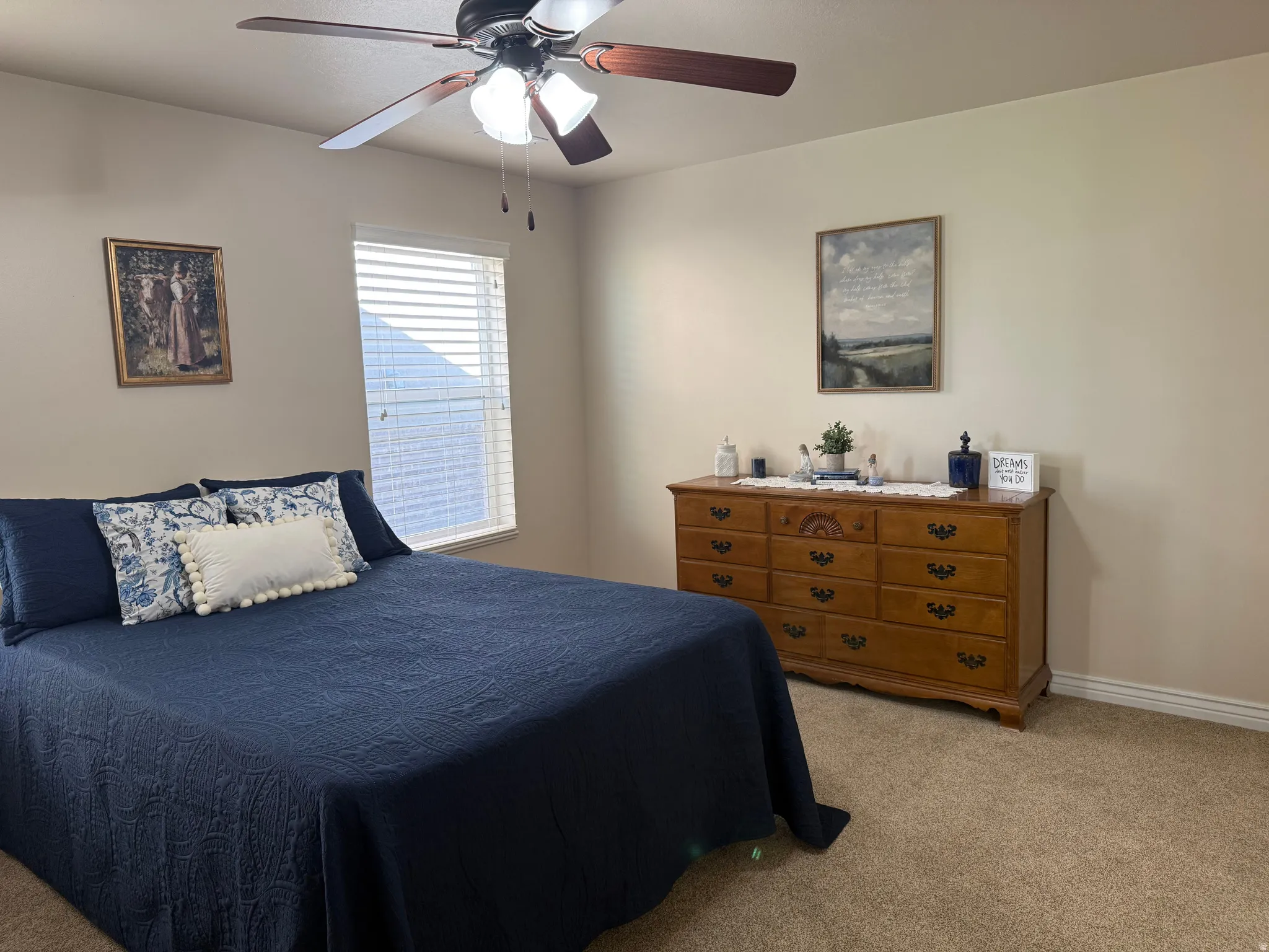 Carpeted room featuring neutral-toned walls and a window with horizontal blinds