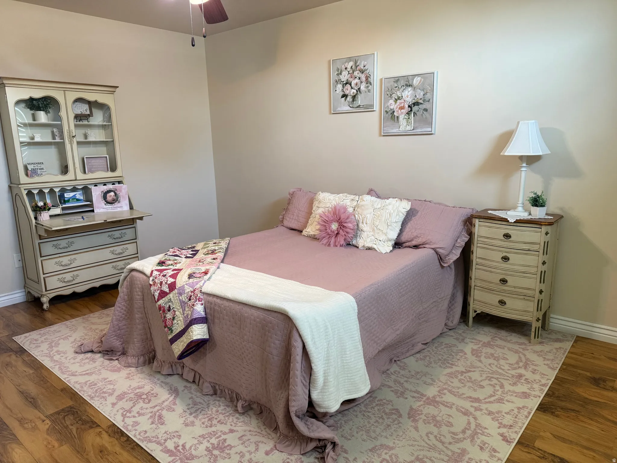 Warm wood-finish flooring complements the neutral wall color