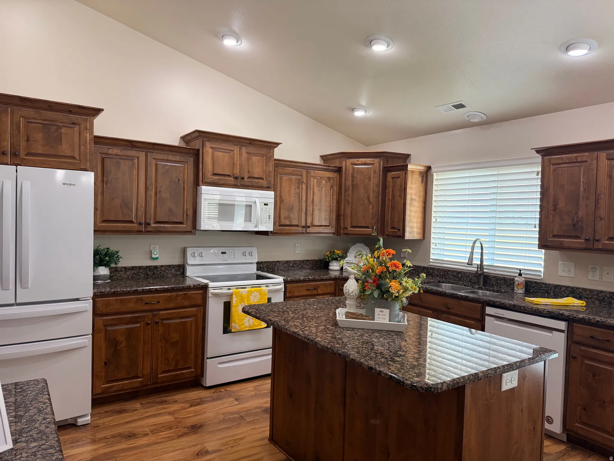 Kitchen featuring wood-finish flooring, recessed lighting, and a vaulted ceiling