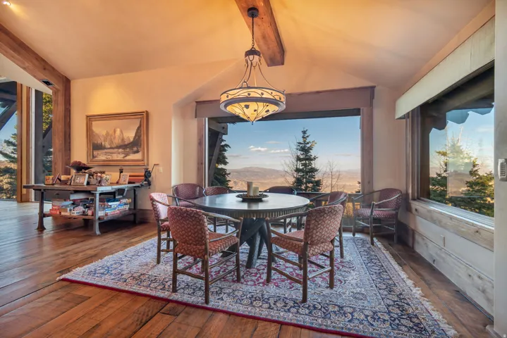 Dining area with expansive windows featuring mountain and valley scenery