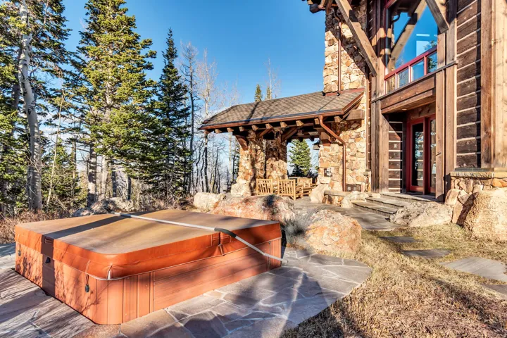 Outdoor spa with cover set on flagstone patio