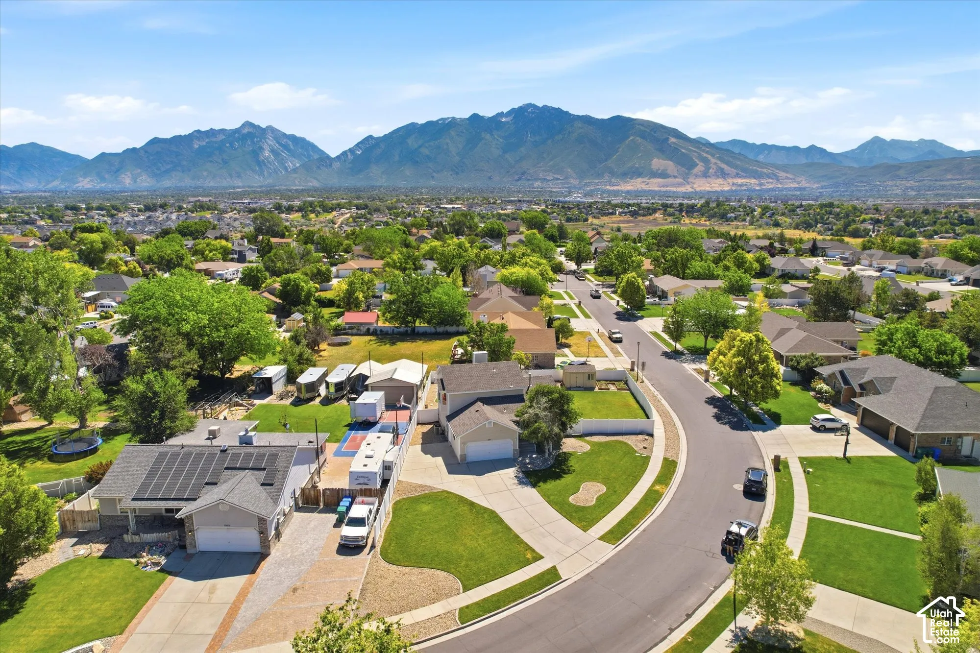 Aerial perspective showcasing a residential neighborhood with mountain scenery