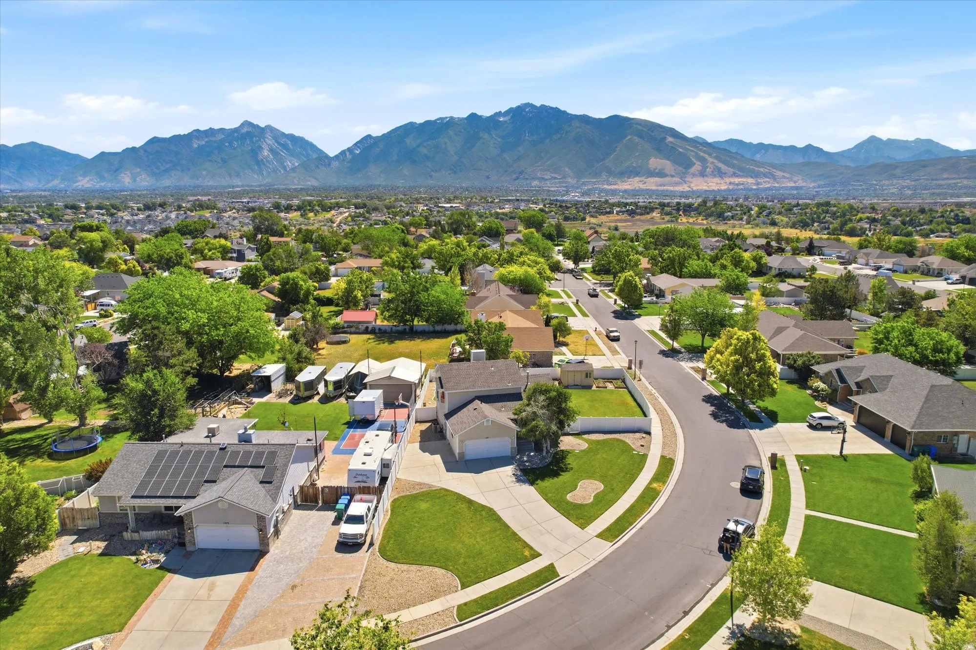 Aerial perspective showcasing a residential neighborhood with mountain scenery