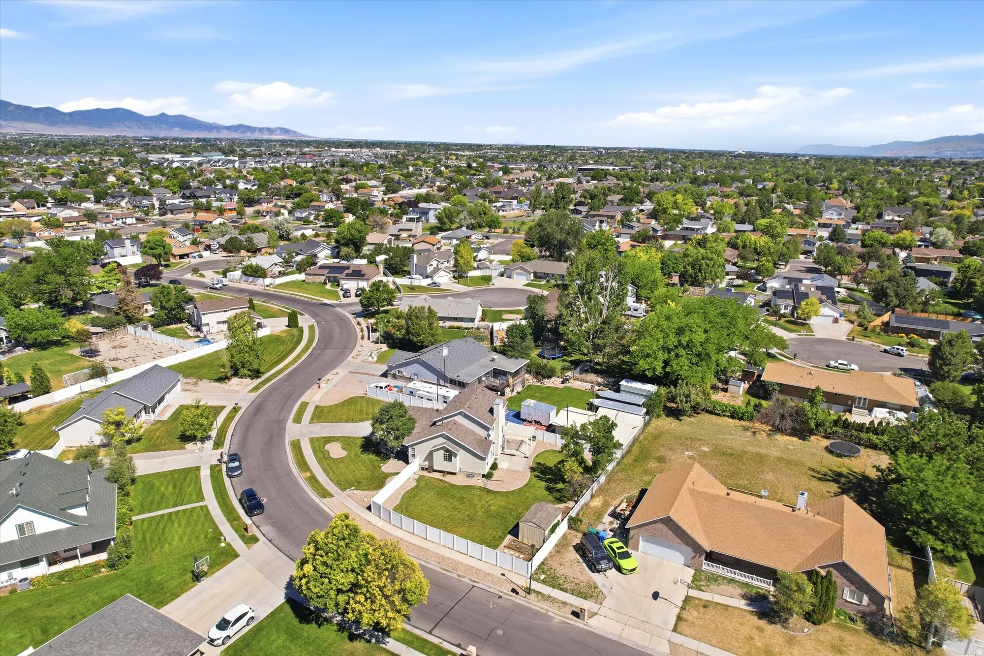 Expansive residential neighborhood featuring numerous single-story homes with varied rooflines and extensive green landscaping