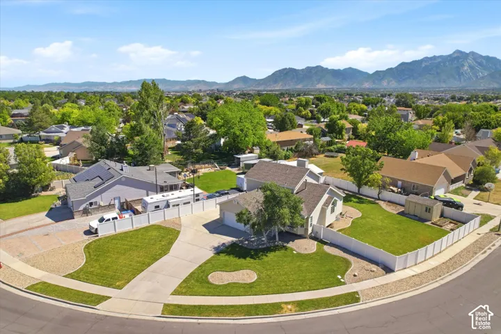 Residential property featuring a spacious cul-de-sac lot, concrete driveway, and white privacy fencing