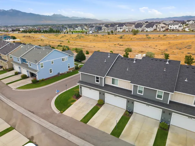 Townhome community featuring multi-level residences with attached garages and paved driveways