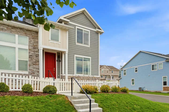 Multi-level exterior featuring a prominent red entry door