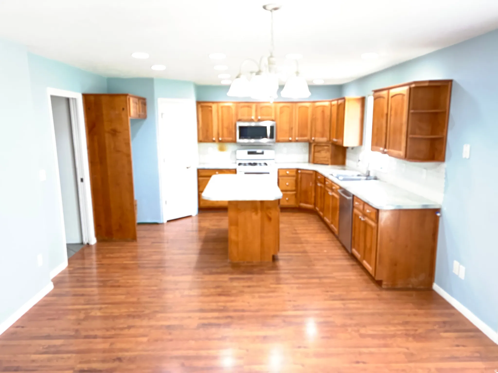 Kitchen and dining area with solid wood cabinets and laminate flooring