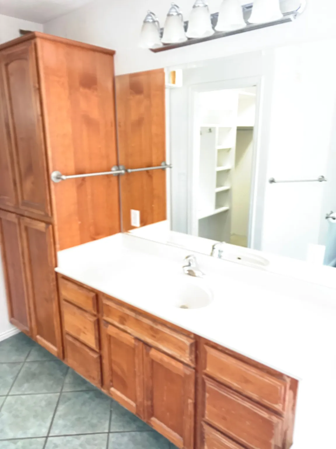 Master Bathroom vanity featuring wood-finish cabinetry, and tiled flooring