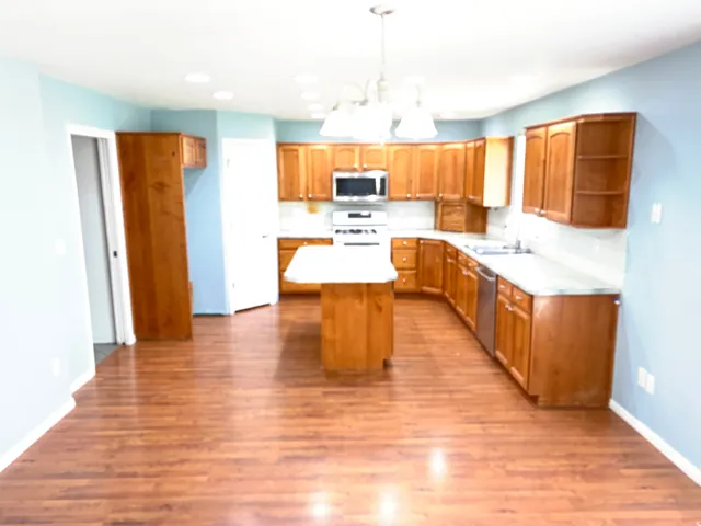 Kitchen and dining area with solid wood cabinets and laminate flooring