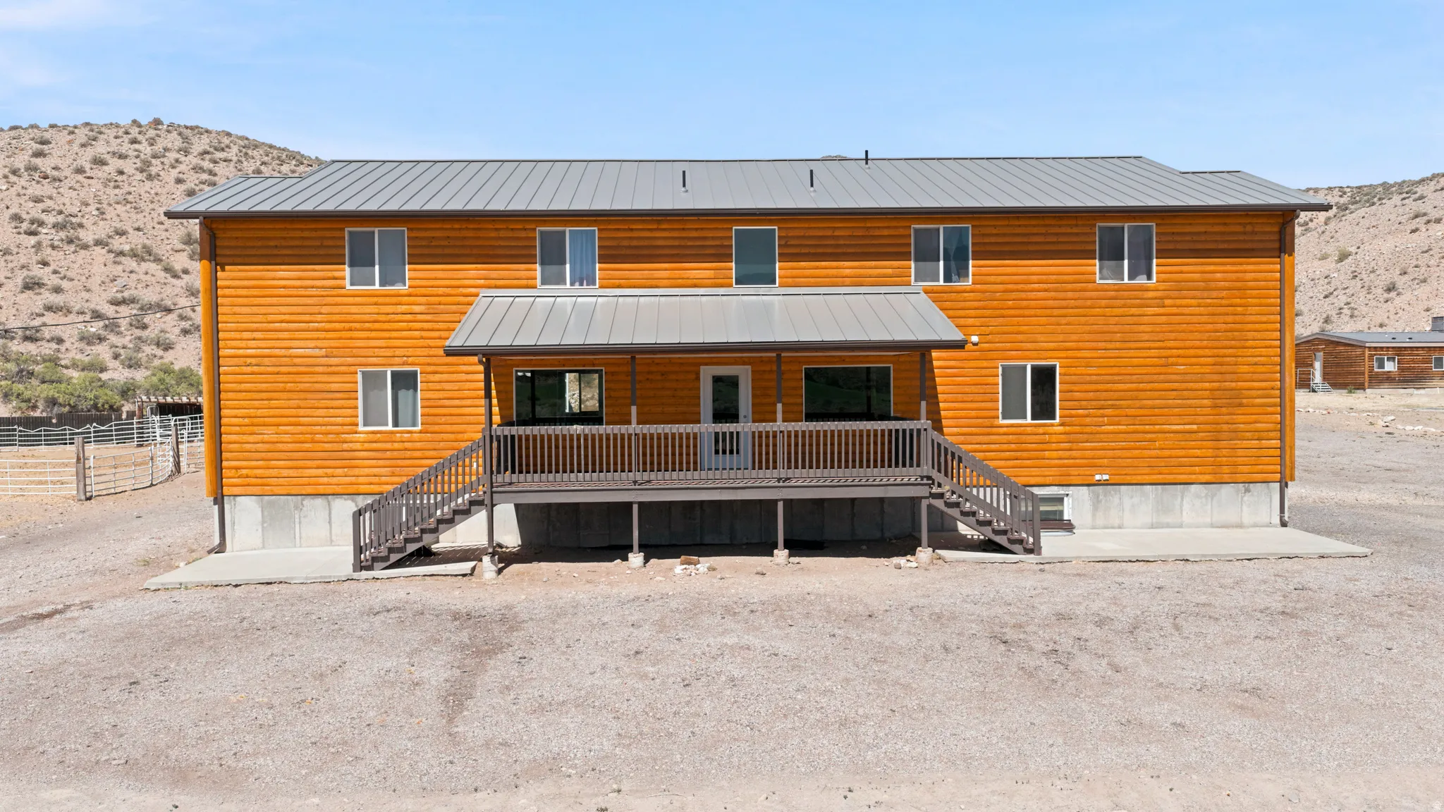 Two-story residence featuring wood-finish siding and a metal roof