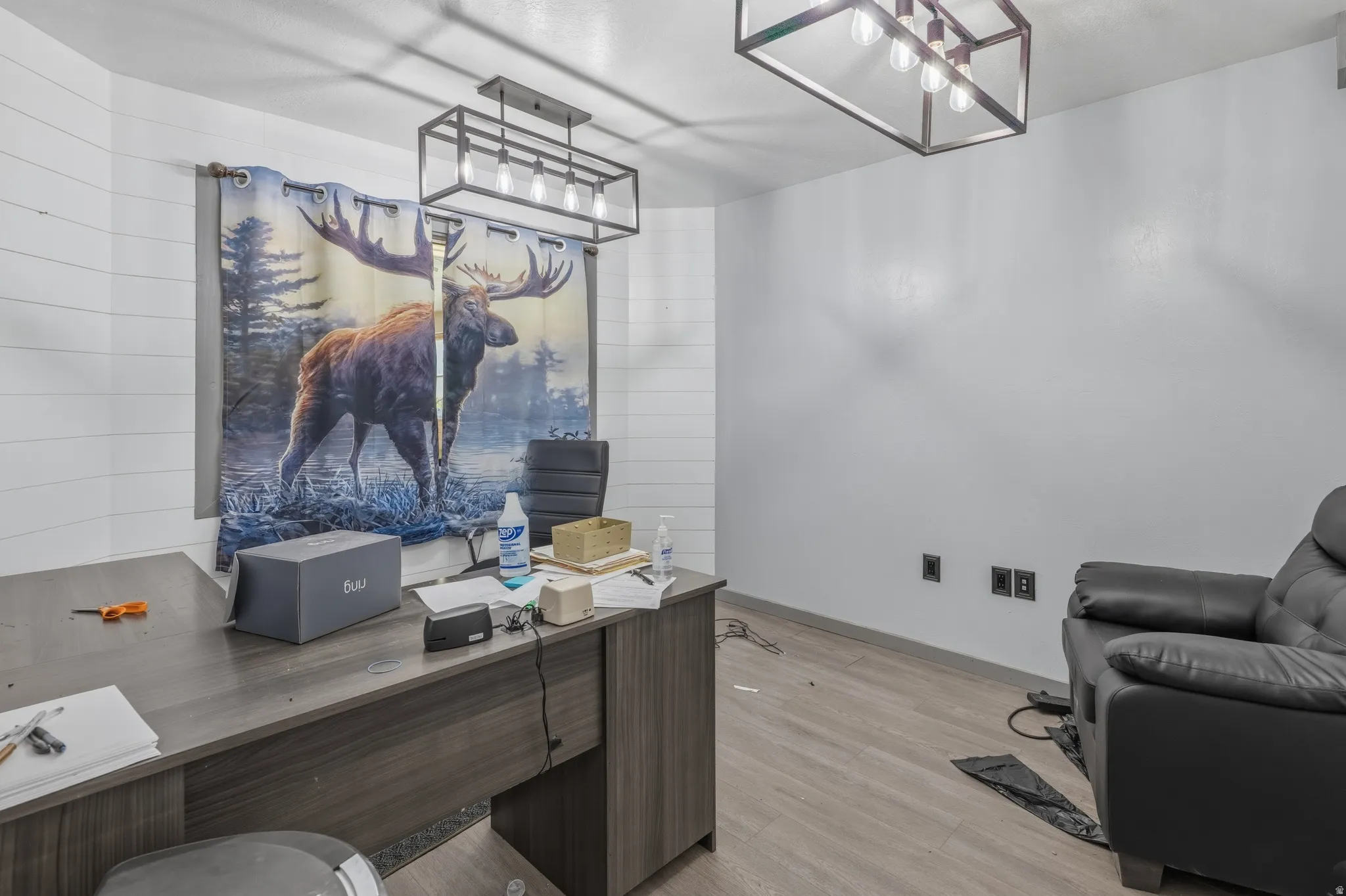 Wall-mounted shiplap accent wall with a flush-mount linear light fixture