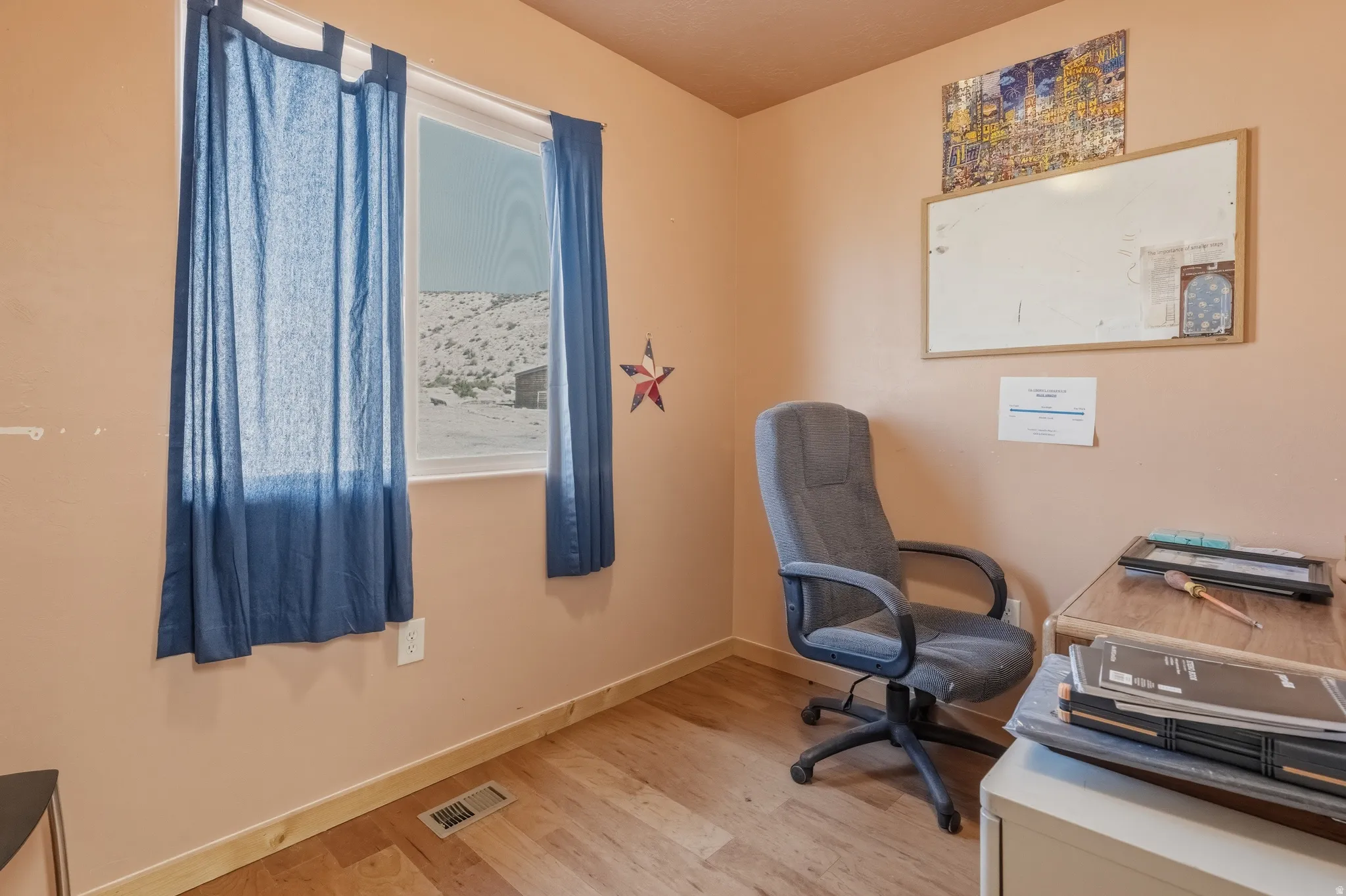 Light peach wall paint with wood-finish flooring