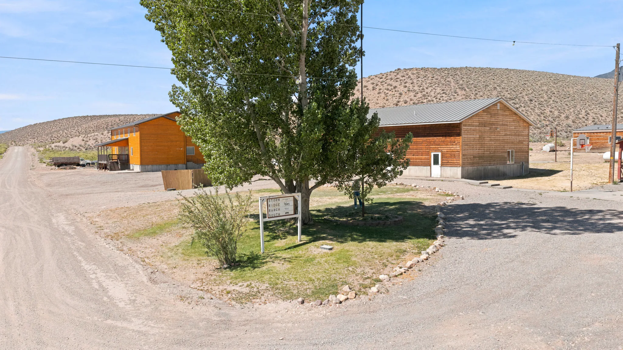 Wood-sided building with a light gray metal roof and a white entry door