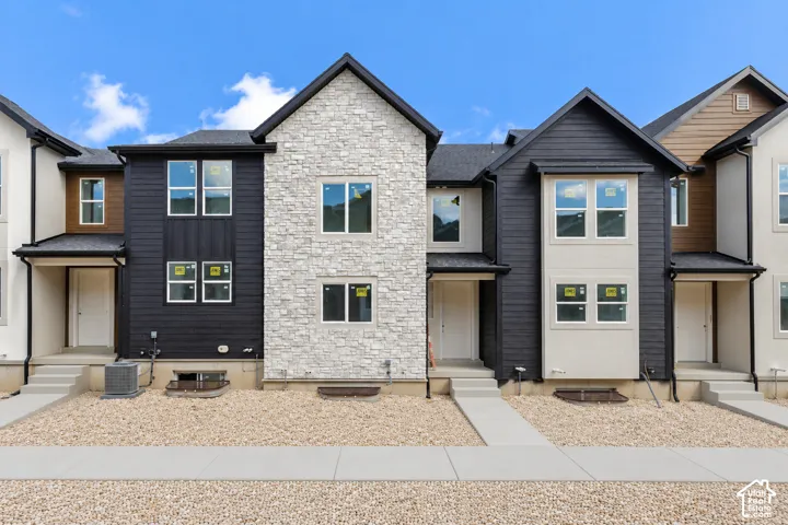 Contemporary townhome exteriors featuring varied siding materials, gabled rooflines, and individual entryways