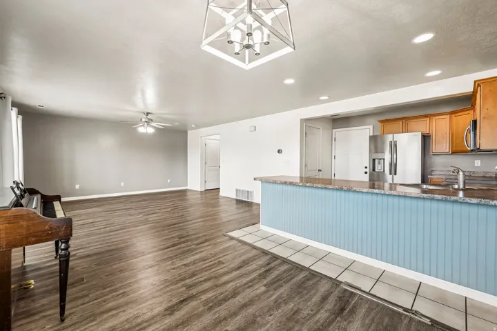 Open-concept living space featuring wood-finish flooring and a ceiling fan