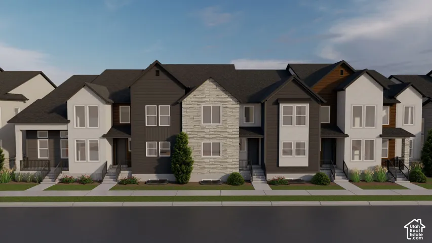 Modern townhome facade featuring dark siding, light stucco, and stone accents