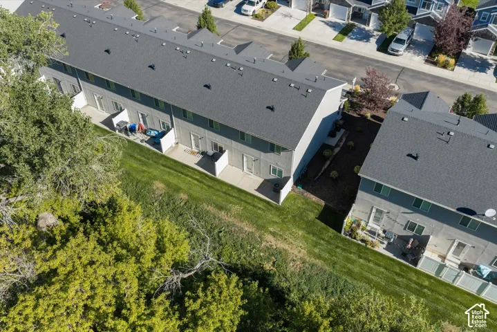 Row of multi-level townhomes with dark gray shingle roofs