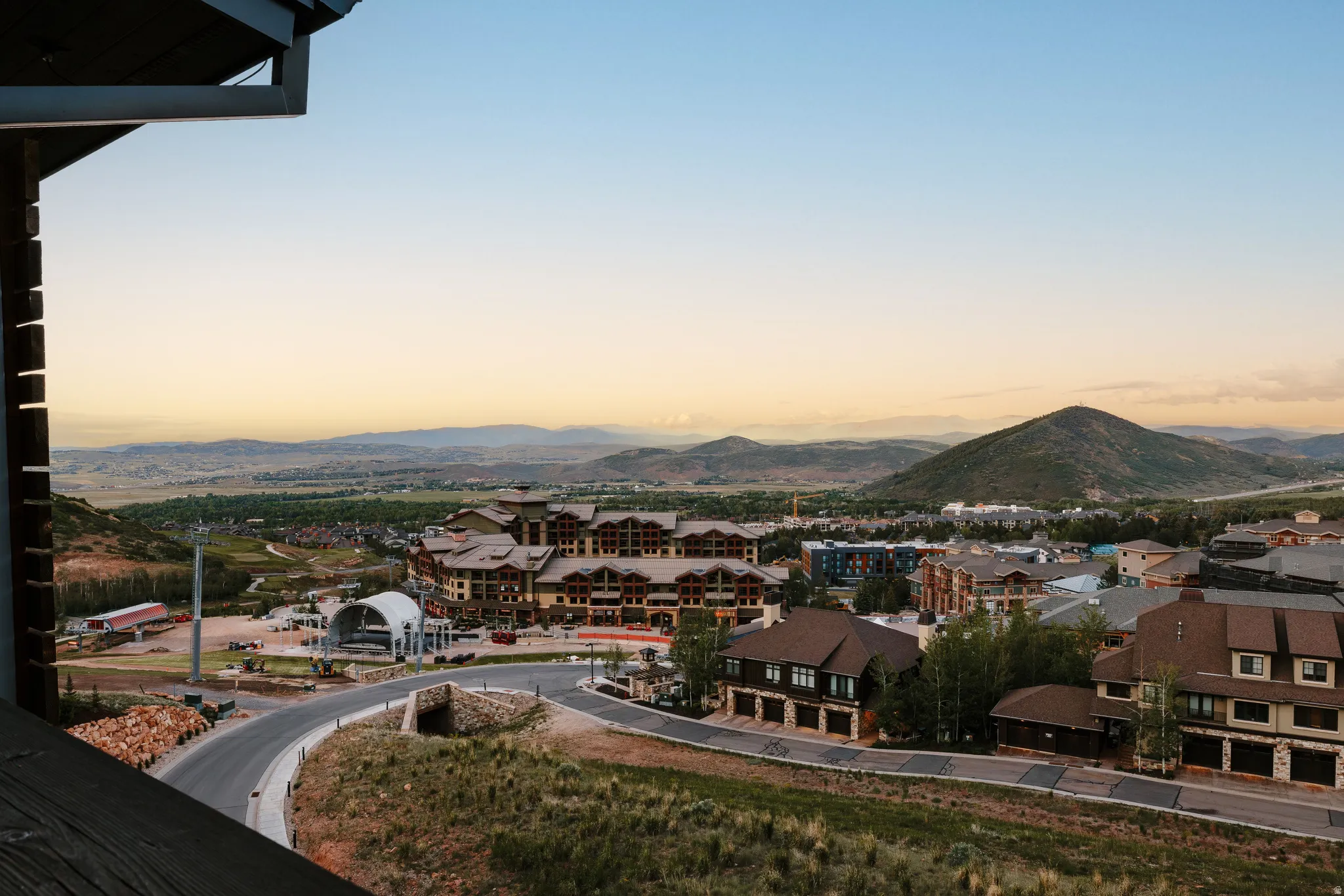Elevated perspective showcasing a mountain backdrop and a developed community with varied architectural styles